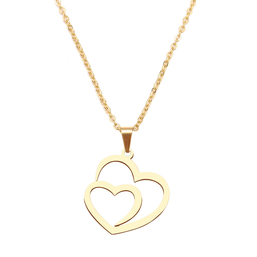Gold necklace with a heart-shaped pendant on a white background