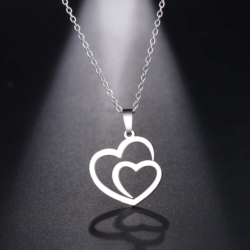 Silver necklace with a double heart pendant on a dark background