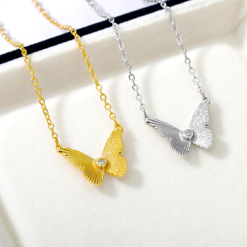 Gold plated butterfly zircon pendant necklace on delicate clavicle chain