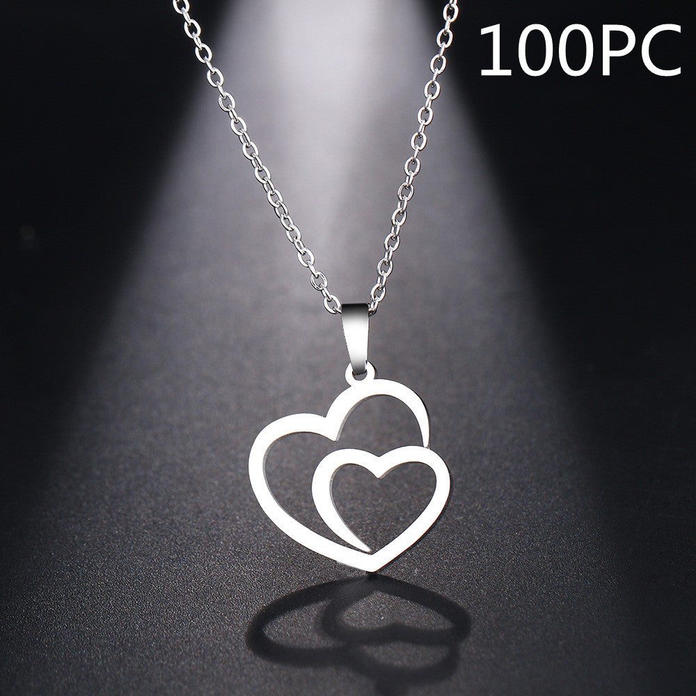 Silver necklace with a double heart pendant on a dark background