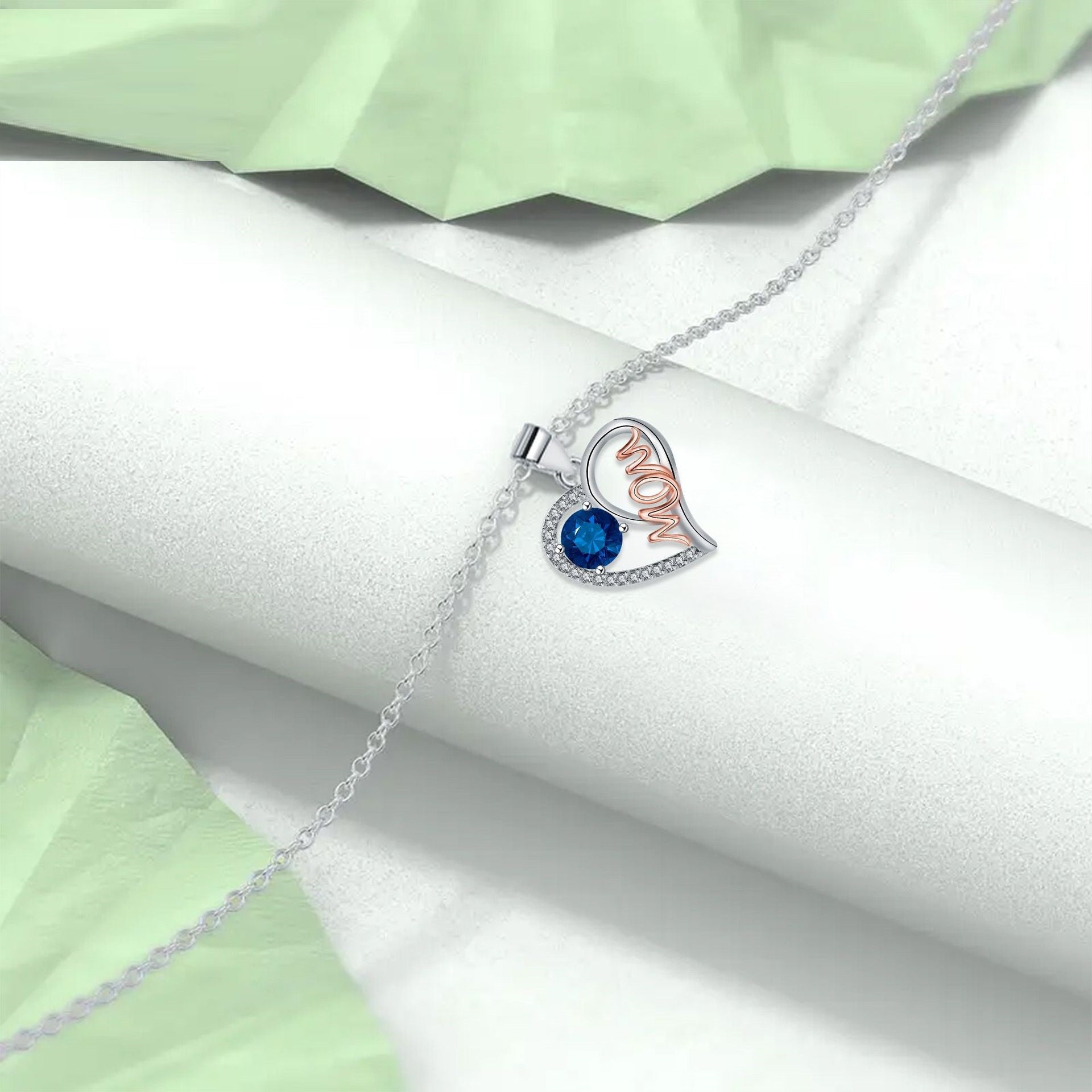 Elegant heart-shaped Mom necklace in red, purple, blue, and pink copper with cross chain design