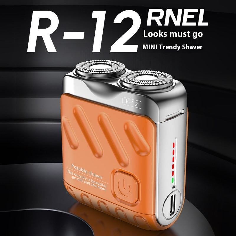 Orange and silver R-12 RNEL mini trendy shaver on a dark background