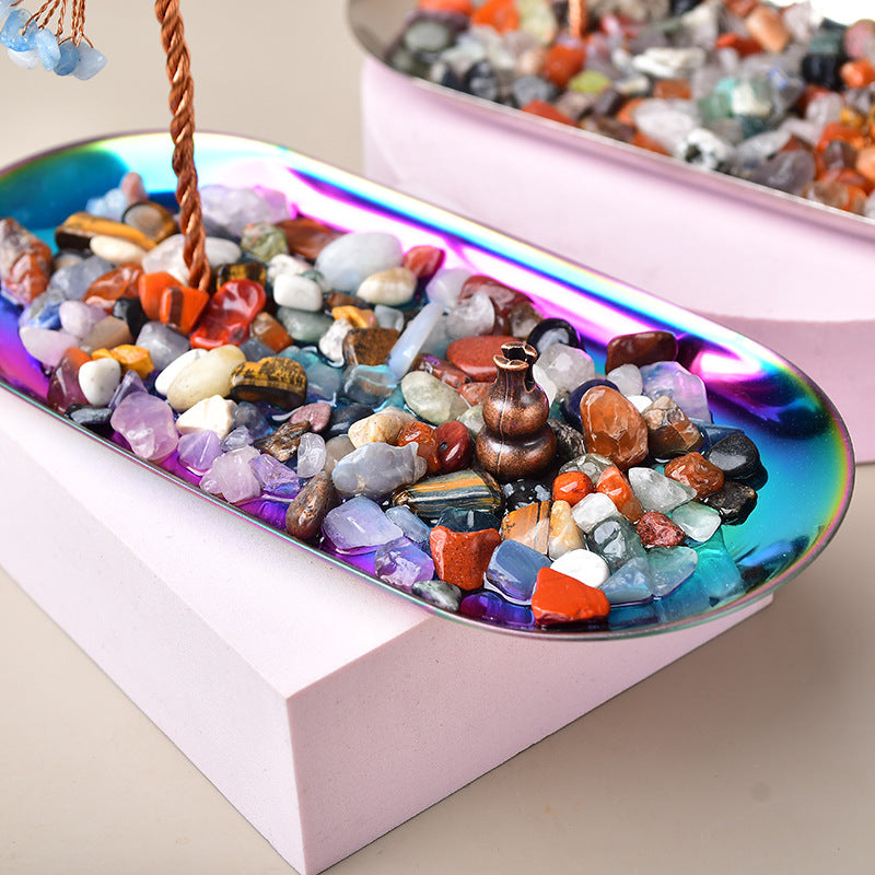 Colorful stones in a reflective dish with a pink base